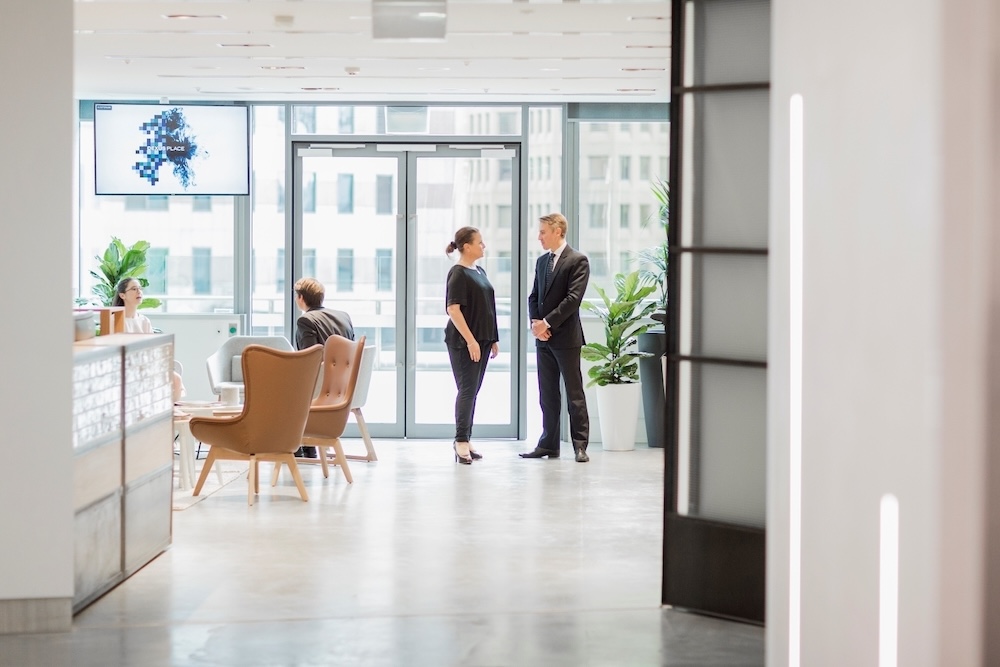 Employees milling about in a communal area of an office.