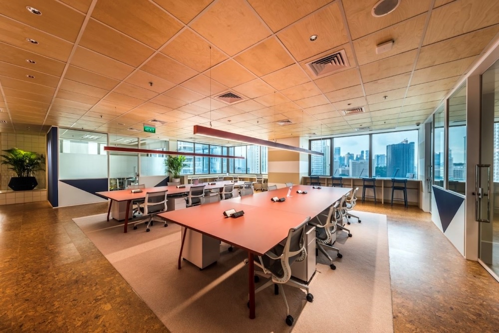 An open plan office layout with shared desks.