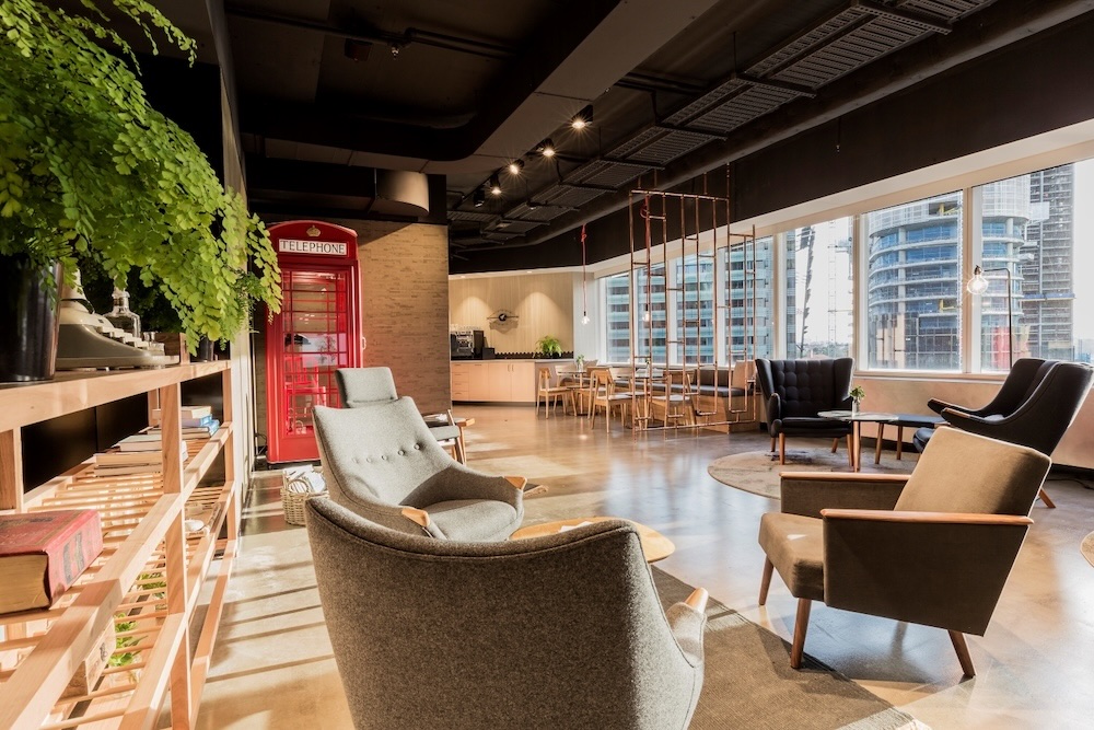Modern coworking lounge space with natural light in a high-rise office space.