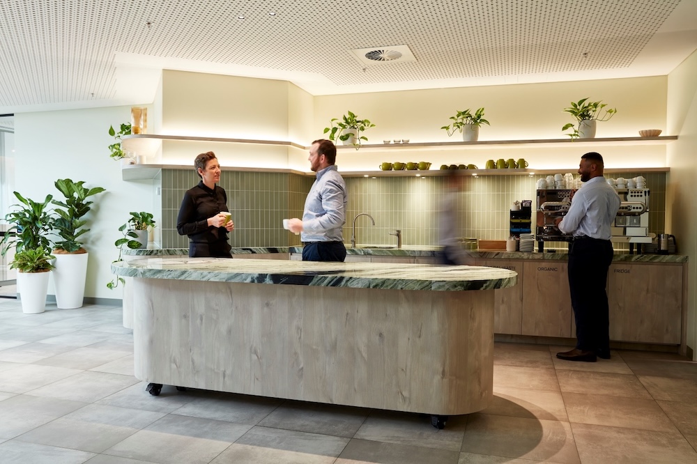 The pantry space at The Work Project 480 Queen Street, Brisbane features a biophilic design that uses a mix of plants and a green colour scheme.