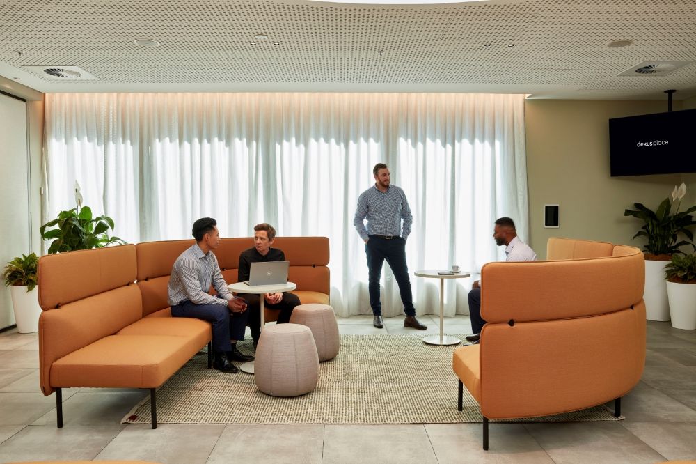 Professionals mingle in a shared space at The Work Project 480 Queen Street, Brisbane.